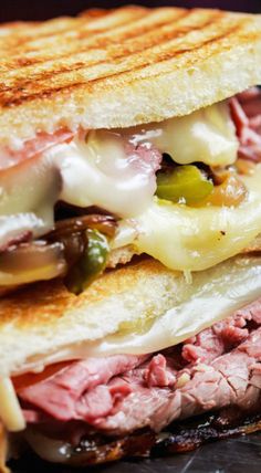 a grilled sandwich with meat, cheese and peppers