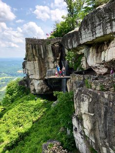 people are standing on the edge of a cliff