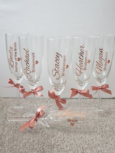 four wine glasses with pink bows on them