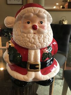 a santa clause figurine sitting on top of a table