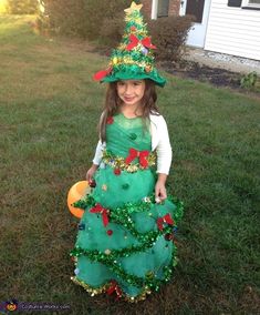 Angela: This is my beautiful daughter Isabella, age 5, who is dressed as a beautiful Christmas tree!! Isabella was a flower girl in a wedding September and I knew the dress... Diy Christmas Tree Dress, Girls Elf Costume Diy, Dress Like A Christmas Tree For School, Dress Up Like A Christmas Tree Kids, Tree Fancy Dress Ideas For Kids, Christmas Tree Costume Kids, Christmas Tree Halloween Costume, Christmas Tree Costume Diy, Tree Costume Diy