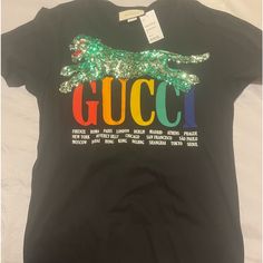 Gucci T Shirt Never Worn Gucci Designer Black T-shirt, Gucci Black T-shirt With Logo Print, Designer Gucci Black T-shirt, Gucci Black Tops With Letter Print, Black Gucci Tops With Letter Print, Trendy Gucci Tops With Letter Print, Gucci Black Short Sleeve Tops, Black Gucci Short Sleeve T-shirt, Casual Multicolor Gucci Tops