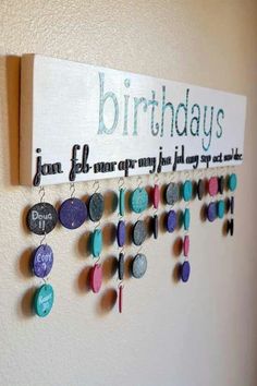 a birthday sign hanging on the wall with buttons and magnets attached to it's side