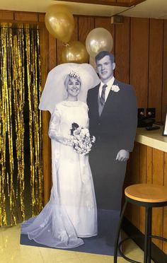 a wedding photo is displayed in front of balloons