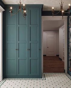 an empty hallway with blue cabinets and lights