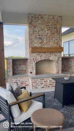 an outdoor living room with a fireplace and seating area