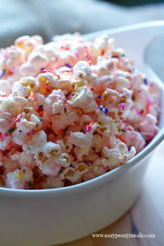 a white bowl filled with sprinkles on top of a table