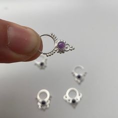 These are soooooo pretty. Made is 925 sterling silver with tribal details, set with a bright amethyst  stone. The rings are all 1cm (.40”) in diameter. The wire is 20 gauge.Stones shine light through them since the back is open. Hard to see this when they are lying flat in the pic. Each piece is made BY HANDOne of the images contains numbers to specify which you would like from the drop down menu. Sterling Silver Body Jewelry, Silver Stackable Amethyst Birthstone Rings, Dainty Sterling Silver Amethyst Ring, Silver Stackable Amethyst Jewelry, Dainty Silver Sterling Silver Septum Ring, Dainty Sterling Silver Septum Ring In Silver, Dainty Silver Sterling Septum Ring, Silver Amethyst Stackable Jewelry, Silver Stackable Amethyst Rings