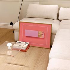 a living room with a couch, coffee table and matchestick holder on the floor