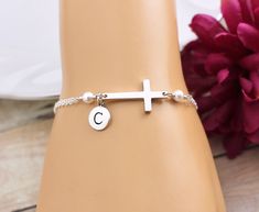 "Sideways Cross Bracelet. PLEASE CLICK \"MORE\" BELOW TO READ FULL DESCRIPTION and sizing information. This simple and elegant Cross Bracelet features a sterling silver Cross accented with two Swarovski Pearls and a sterling silver initial on a sterling silver chain finished with a lobster clasp closure. Bracelet is solid sterling silver, fully adjustable and comes with the option to add a complimentary, custom printed gift tag. BRACELET DETAILS: * Sterling silver cable chain finished with a sec Silver Cross Bracelets For Gifts, Nickel Free Silver Name Bracelet, Silver Cross Chain Bracelet As Gift, Nickel-free Silver Name Bracelet, Elegant Nickel-free Name Bracelet, Elegant Personalized Cross Bracelets, Adjustable Cross Bracelets For Wedding, Adjustable Cross Bracelets For Weddings, Hypoallergenic Sterling Silver Bracelets For Wedding