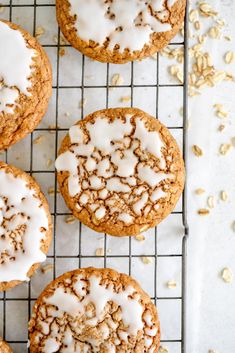 cookies with white icing on a cooling rack