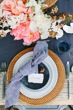 a place setting with flowers and napkins