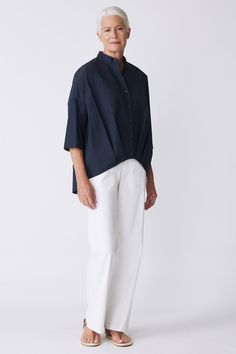 Be anything but ordinary in our Pleat Hem Kimono Shirt. Made in our Italian Broadcloth, this top has an attitude all of its own. Perfect for travel, pair with our Broadcloth bottoms or with your favorite denim. Button front closure, band shape collar, drop shoulder fit, 3/4 sleeve length with 2-ply cuff, shaped hemline with angled pleats, and center back pleat detail. - 51% Cotton, 49% Nylon - Fabric Woven in Italy - Made in NYC - Dry clean or machine wash - Our model is 5'9" wearing size S - Chest 53", Bottom Opening 44", Front Length 24" Orders are processed within three business days (not including weekends or holidays). All pre-orders are charged at the time of purchase and shipped on the date indicated on each style. All returns are subject to a per order restocking fee. Please visit Modern Tops With Pockets For Daywear, Modern Cotton Blouse With Shirttail Hem, Chic Tops With Relaxed Fit And Straight Hem, Kimono Shirt, Drop Shoulder Top, Flounced Dress, Nylon Fabric, V Neck Dress, Drop Shoulder