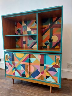 a colorful painted cabinet with geometric shapes on it