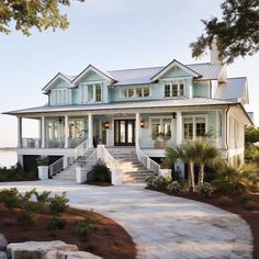 a large white house sitting on top of a lush green field