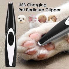 a cat paw being held by a black and white electric toothbrush with pictures of cats on it