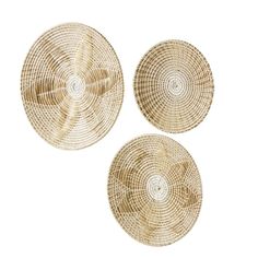 three woven plates with circular designs on the top, one in gold and one in white