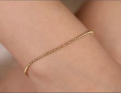 This simple yet elegant Ball Chain Bracelet will fit any style. You'll love the versatility of this bracelet. Mix it up to create your own fashion rules. Comes in 3 sizes for a comfortable fit. - Handmade- Solid Gold- Chain Width: 1 mm - 1.3 mm - 1.5 mm- High-End Polish All pieces come beautifully boxed in suede pouches you can always use (which really comes in handy when traveling!) Minimalist Beaded Bracelets With Satellite Chain, Classic Gold Bracelet With Satellite Chain As Gift, Everyday Ball Chain Bracelet, Minimalist Gold Bracelet With Ball Chain, Everyday Chain Bracelet With Round Beads, Dainty 14k Gold Bracelets With Round Beads, Elegant Satellite Chain Bracelet, Elegant Ball Chain Bracelet, Dainty Hypoallergenic Bracelets With Round Beads