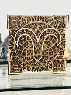 an intricately designed wooden card case on top of a glass table