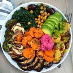 a white bowl filled with different types of vegetables