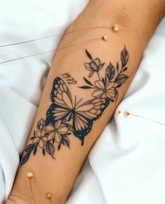 a woman's arm with a butterfly tattoo on it