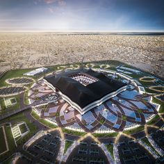 an aerial view of a stadium in the middle of a city with lots of buildings