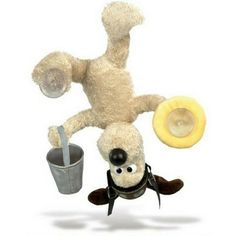 a stuffed animal that is upside down in the air next to a cup and banana