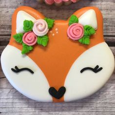 a cake shaped like a fox with flowers on it