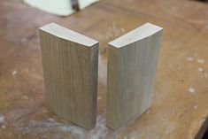 two pieces of wood sitting on top of a wooden table