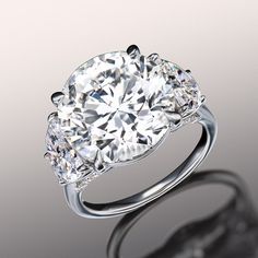 a three stone diamond ring on a reflective surface