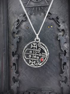 This Sigil of Gaap necklace is an handmade pewter sculpture with a gem of your choice (my favorite is the red abalone, if you are looking for a very nice bloody red) This seal of Gaap is one of the 72 Sigils of Goetia from Ars Goetia's Demonology This Sigil of Goetia pendant is sold with a free 18'' stainless steel chain, if you would like to have a different length for the chain, you can write the desired length in the private note section when ordering :) This Seal of Gaap is a pendant of 3cm Engraved Pewter Jewelry Gift, Silver Pewter Round Jewelry, Silver Pewter Jewelry, Symbolic Antique Silver Pewter Jewelry, Soldered Pewter Jewelry For Gift, Soldered Pewter Jewelry Gift, Round Pewter Jewelry As Gift, Round Pewter Jewelry Gift, Symbolic Pewter Jewelry For Collectors