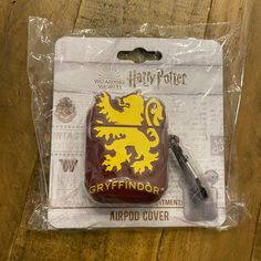 a harry potter gryffindor shaped air freshener with a pen in it