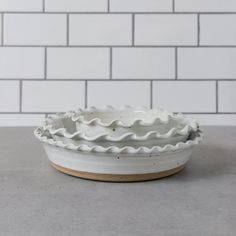 a white ceramic bowl sitting on top of a counter