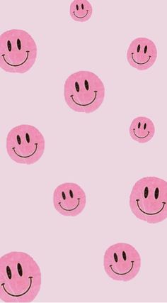 a pink background with smiley faces on it