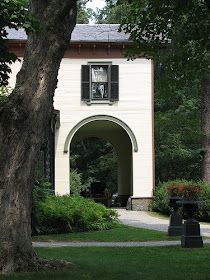 a white building surrounded by trees and bushes