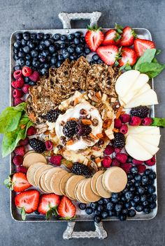 an assortment of fruits and pastries on a platter