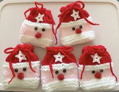 four knitted christmas mitts with stars on them