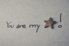 a small star is sitting on top of a piece of paper that says, you are my