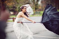 a woman in a wedding dress holding an umbrella