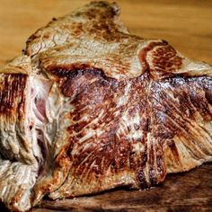 a piece of meat sitting on top of a wooden table