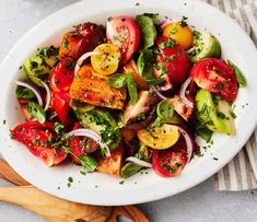 a white bowl filled with lots of different types of vegetables