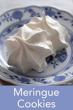 meringue cookies on a blue and white plate with the words meringue cookies