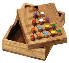 a wooden box with two pieces of game in the shape of a checker board