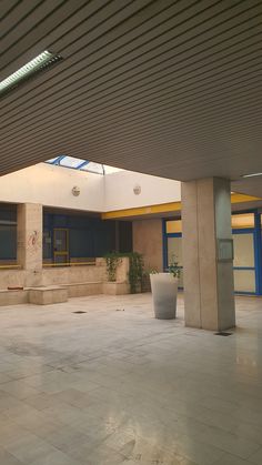 an empty building with two planters in the middle