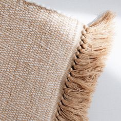 a close up view of the back side of a pillow with fringes on it