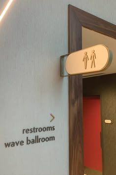 the restrooms wave ballroom sign is on the wall above the door to the bathroom