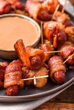 bacon wrapped skewers with dipping sauce on the side