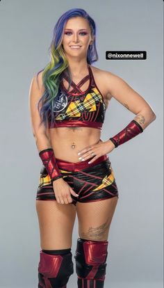 a woman with colorful hair and tattoos posing for a photo in her wrestling outfit, wearing knee - high boots