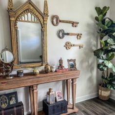 a wooden table topped with a mirror next to a potted plant