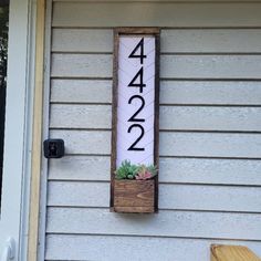 a house number sign mounted to the side of a building